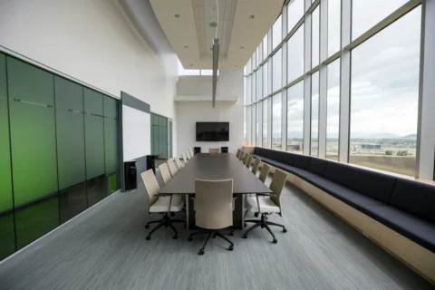 A spotless conference room with clean surfaces and organized seating.